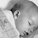 A baby sleeping with the Xbox Game Pass logo on it.